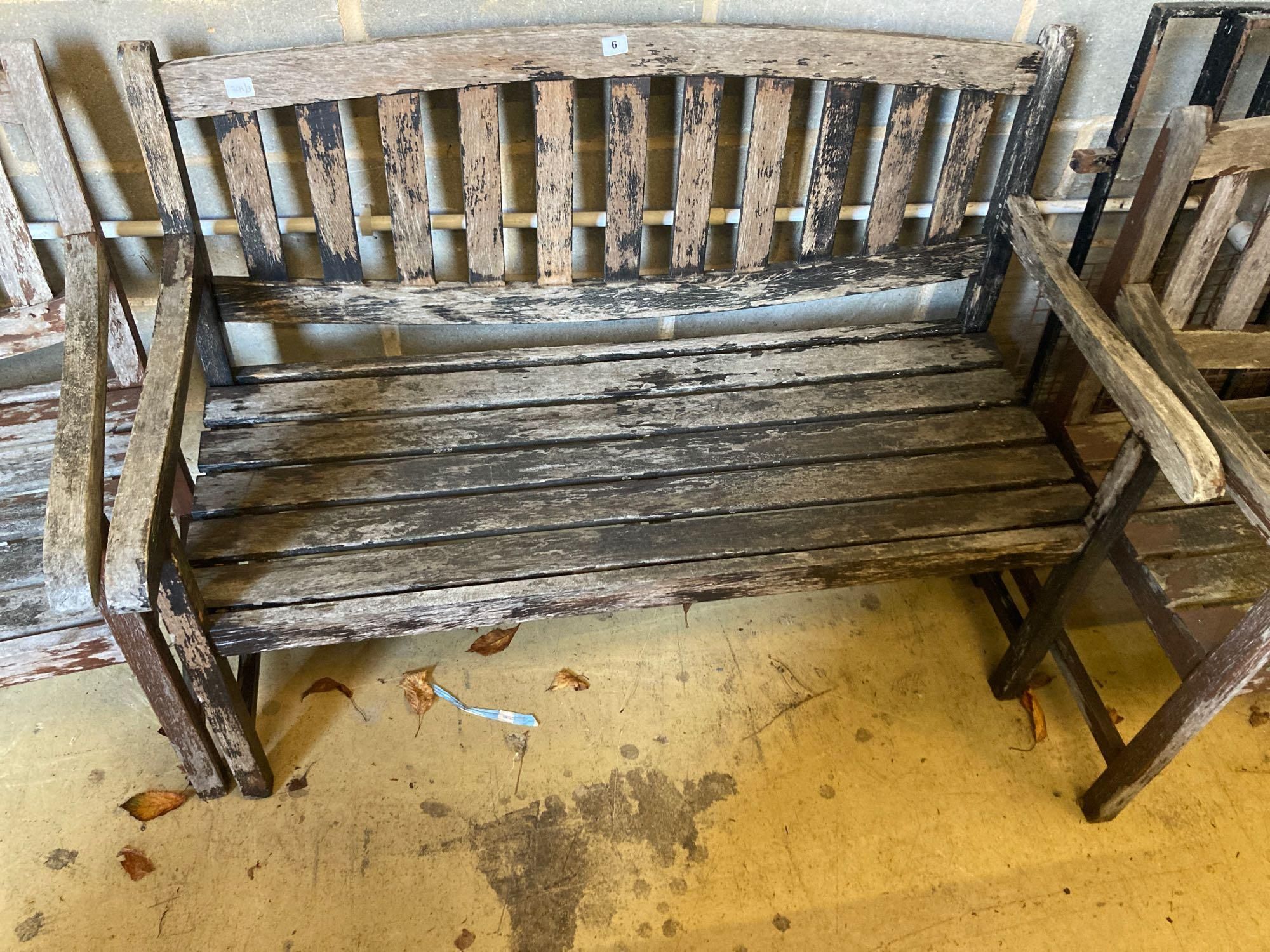 Two stained teak garden benches and matching armchairs, bench widths 126cm and 123cm